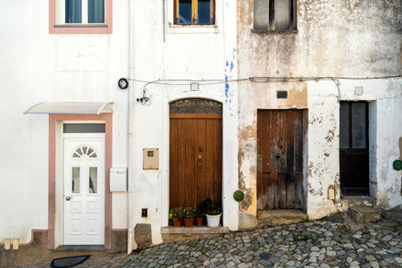 Four doors in whitewashed houses of mountainous Monchique, Algarve, Portugalの写真素材
