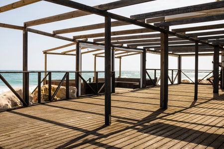 Wooden beachfront terrace during sunny day, Algarve, Portugal