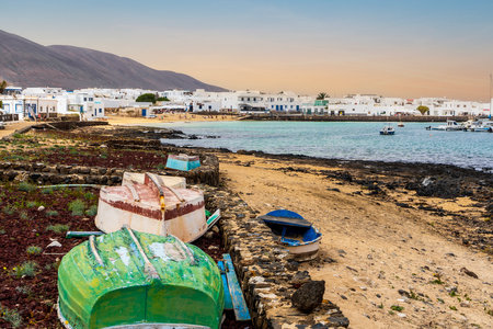 La Graciosa landscape - colorful boats on a shore and white architecture of Caleta del Sebo, Canary Islands, Spainの写真素材