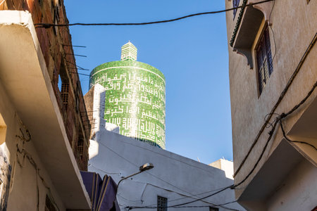 Important green tower with arabic letters in Moulay Idriss downtown, Morocco, North Africaの写真素材