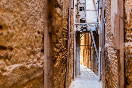 Narrow street of Arabic old town called medina in Fes, Morocco, North Africaの写真素材