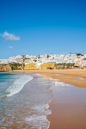 Great view of Fisherman Beach, Praia dos Pescadores, with whitewashed houses on cliff, reflecting on the sea, blue sky, summer time, Albufeira, Algarve, Portugalの写真素材