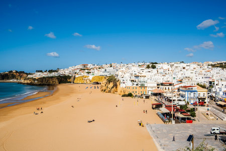 Great view of Fisherman Beach, Praia dos Pescadores, with whitewashed houses on cliff, reflecting on the sea, blue sky, summer time, Albufeira, Algarve, Portugalの写真素材