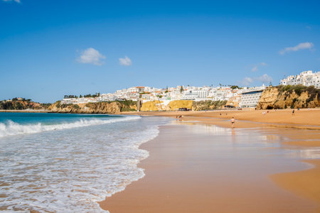 Great view of Fisherman Beach, Praia dos Pescadores, with whitewashed houses on cliff, reflecting on the sea, blue sky, summer time, Albufeira, Algarve, Portugalの写真素材