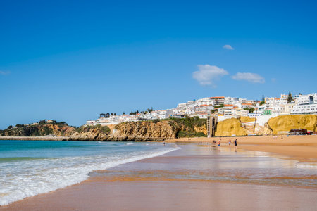 Great view of Fisherman Beach, Praia dos Pescadores, with whitewashed houses on cliff, reflecting on the sea, blue sky, summer time, Albufeira, Algarve, Portugalの写真素材