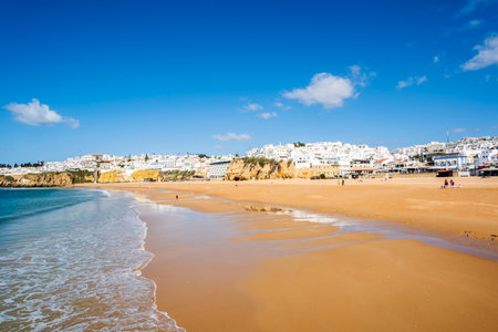 Great view of Fisherman Beach, Praia dos Pescadores, with whitewashed houses on cliff, reflecting on the sea, blue sky, summer time, Albufeira, Algarve, Portugalの写真素材
