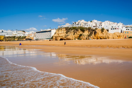 Great view of Fisherman Beach, Praia dos Pescadores, with whitewashed houses on cliff, reflecting on the sea, blue sky, summer time, Albufeira, Algarve, Portugalの写真素材