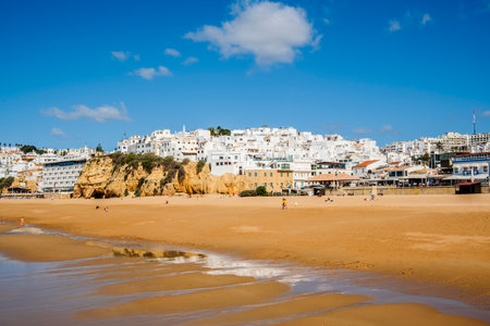 Great view of Fisherman Beach, Praia dos Pescadores, with whitewashed houses on cliff, reflecting on the sea, blue sky, summer time, Albufeira, Algarve, Portugalの写真素材