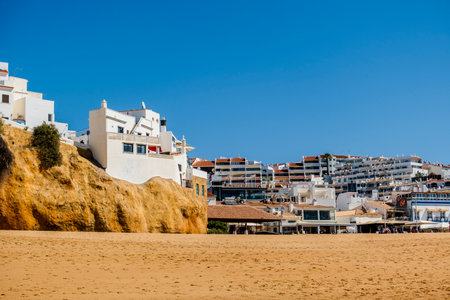 Great view of Fisherman Beach, Praia dos Pescadores, with whitewashed houses on cliff, reflecting on the sea, blue sky, summer time, Albufeira, Algarve, Portugalの写真素材