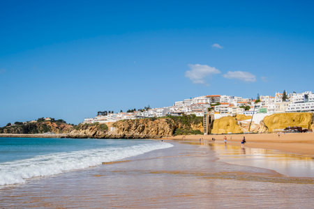Great view of Fisherman Beach, Praia dos Pescadores, with whitewashed houses on cliff, reflecting on the sea, blue sky, summer time, Albufeira, Algarve, Portugalの写真素材