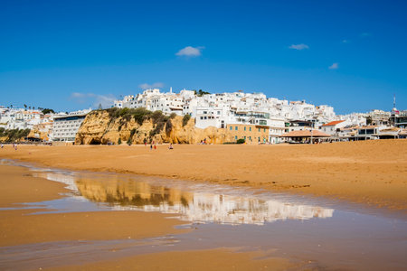 Great view of Fisherman Beach, Praia dos Pescadores, with whitewashed houses on cliff, reflecting on the sea, blue sky, summer time, Albufeira, Algarve, Portugalの写真素材