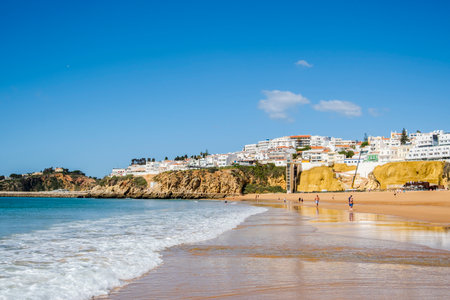 Great view of Fisherman Beach, Praia dos Pescadores, with whitewashed houses on cliff, reflecting on the sea, blue sky, summer time, Albufeira, Algarve, Portugalの写真素材