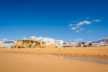 Great view of Fisherman Beach, Praia dos Pescadores, with whitewashed houses on cliff, reflecting on the sea, blue sky, summer time, Albufeira, Algarve, Portugalの写真素材