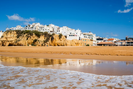 Great view of Fisherman Beach, Praia dos Pescadores, with whitewashed houses on cliff, reflecting on the sea, blue sky, summer time, Albufeira, Algarve, Portugalの写真素材