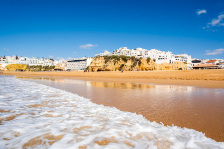 Great view of Fisherman Beach, Praia dos Pescadores, with whitewashed houses on cliff, reflecting on the sea, blue sky, summer time, Albufeira, Algarve, Portugalの写真素材