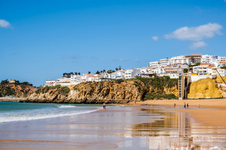Great view of Fisherman Beach, Praia dos Pescadores, with whitewashed houses on cliff, reflecting on the sea, blue sky, summer time, Albufeira, Algarve, Portugalの写真素材