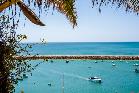 Awesome view of Marina in Albufeira, beautiful summer picture, blue sky and side walk, Fisherman Beach, Praia dos Pescadores, Albufeira, Portugalの写真素材