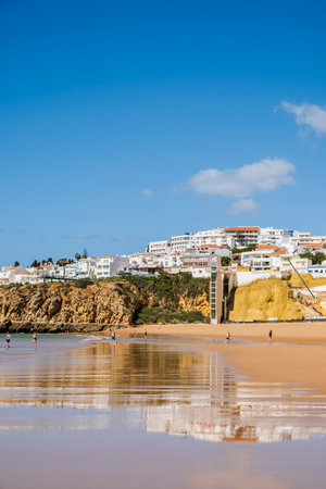Great view of Fisherman Beach, Praia dos Pescadores, with whitewashed houses on cliff, reflecting on the sea, blue sky, summer time, Albufeira, Algarve, Portugalの写真素材