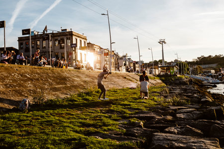 April 17, 2023 - Porto, Portugal: Photographer taking photos of the couple by the Douro riverのeditorial素材