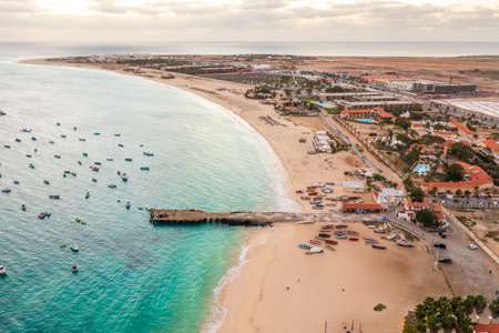 Pier and boats on turquoise water in city of Santa Maria, island of Sal, Cape Verde