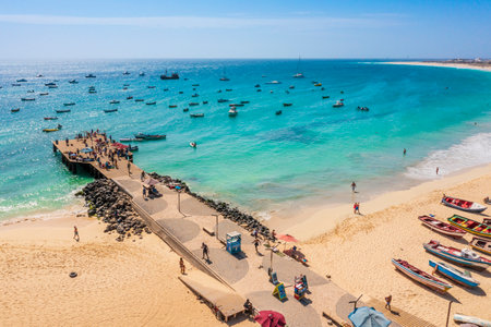 Pier and boats on turquoise water in city of Santa Maria, island of Sal, Cape Verde