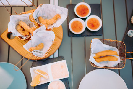 Delicious fried shrimps elegantly served with sauces on the restaurant table, Portugalの写真素材
