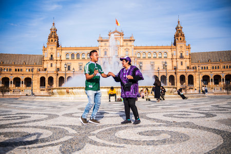 Seville, Spain - March 9, 2022: dancing people in front of the fountain in Plaza de Espana, Seville