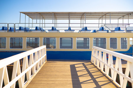 Passenger Ship and Boardwood walk bridge in Faro's Harbour, Portugalの写真素材