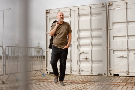 Caucasian Man posing in front of industrial background