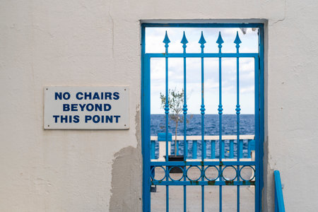 Blue locked door with sign No chairs beyond this point, Maltaの写真素材