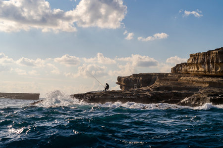 Coast with fishermen next to Marsaxlokk, southern part of Malta