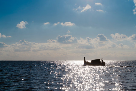 Silhouette of Maltese boat on Mediterranean Sea by Marsaxlokk, Maltaの写真素材