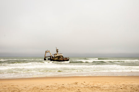 The Zeila shipwreck off Namibia's Skeleton Coast, rusting in the Atlantic surf under cloudy skies...