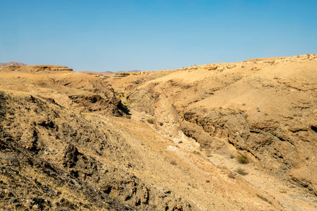A stunning view of Gaub Pass in Namibia, showcasing the winding road through rugged desert mountains and arid landscapes. This remote route, part of the Namib Desert region, captures the beauty, solitude, and adventure of Namibia's natural sceneryの写真素材