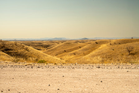 A stunning view of Gaub Pass in Namibia, showcasing the winding road through rugged desert mountains and arid landscapes. This remote route, part of the Namib Desert region, captures the beauty, solitude, and adventure of Namibia's natural sceneryの写真素材