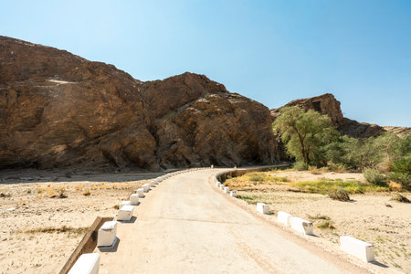 A stunning view of Gaub Pass in Namibia, showcasing the winding road through rugged desert mountains and arid landscapes. This remote route, part of the Namib Desert region, captures the beauty, solitude, and adventure of Namibia's natural sceneryの写真素材