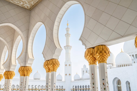 The majestic Sheikh Zayed Grand Mosque in Abu Dhabi, United Arab Emirates, featuring stunning white marble domes, elegant minarets, and intricate Islamic architecture. A symbol of Emirati heritage, faith, and cultural unity.の写真素材