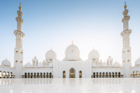 The majestic Sheikh Zayed Grand Mosque in Abu Dhabi, United Arab Emirates, featuring stunning white marble domes, elegant minarets, and intricate Islamic architecture. A symbol of Emirati heritage, faith, and cultural unity.の写真素材