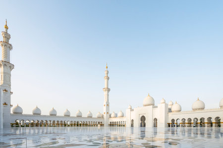 The majestic Sheikh Zayed Grand Mosque in Abu Dhabi, United Arab Emirates, featuring stunning white marble domes, elegant minarets, and intricate Islamic architecture. A symbol of Emirati heritage, faith, and cultural unity.の写真素材