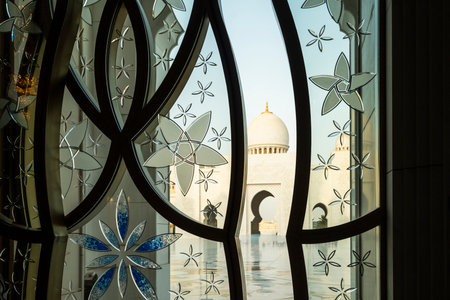 The majestic Sheikh Zayed Grand Mosque in Abu Dhabi, United Arab Emirates, featuring stunning white marble domes, elegant minarets, and intricate Islamic architecture. A symbol of Emirati heritage, faith, and cultural unity.の写真素材