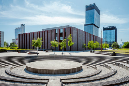 The National Polish Radio Symphony Orchestra (NOSPR) building in Katowice, Poland, captured on a sunny day with the modern .KTW office towers visible in the backgroundの写真素材