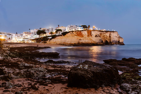 Scenic view of Praia de Carvoeiro in Portugal's Algarve region, featuring cliffs, turquoise waters, and sandy beach. Ideal for travel, tourism, coastal, or summer lifestyle content.の写真素材