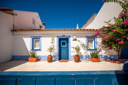 Vila Nova de Milfontes cityscape, Alentejo coast, Portugal. Whitewashed houses, cobblestone streets. European coastal town, travel destination, Mediterranean architecture, summer tourism.の写真素材