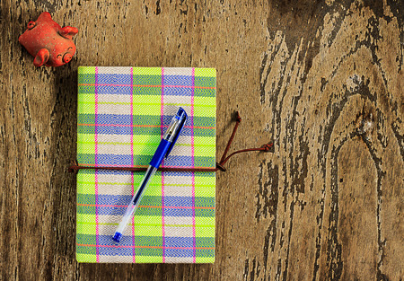 notebook design with pen mark on wood floorの写真素材