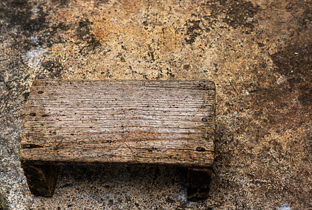 old wooden seats  on cement backgroundの写真素材