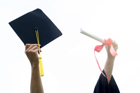 happy student graduate and put hand up with Graduation cap and certificatedの写真素材