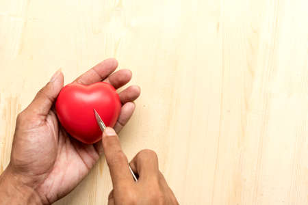 red  pillow heart in hand with Surgery conceptの写真素材