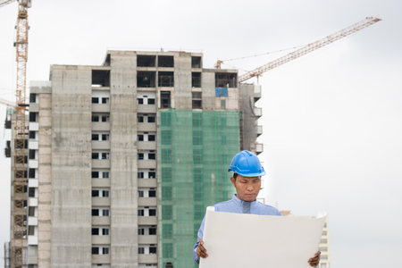 engineer or foreman read blueprint on on construcktion siteの写真素材