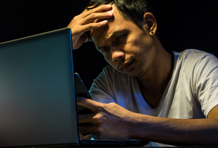 Business asian man is strain with hard job with soft focusの写真素材