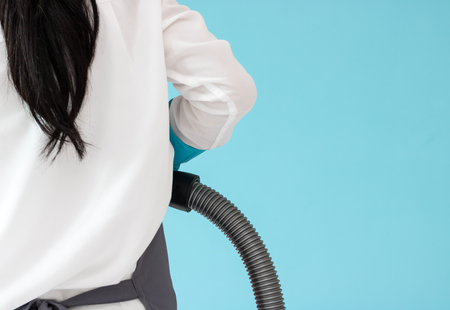 Asian women maid use vacuum cleaner Clean floor wiht working in bedroom in homeの写真素材